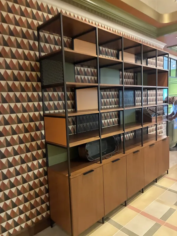 Open shelving above a row of cabinets against the patterned wall at Birdie G's.