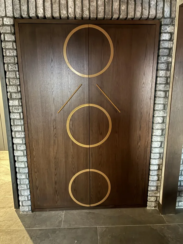 A recessed bar with decorative wood detailing.